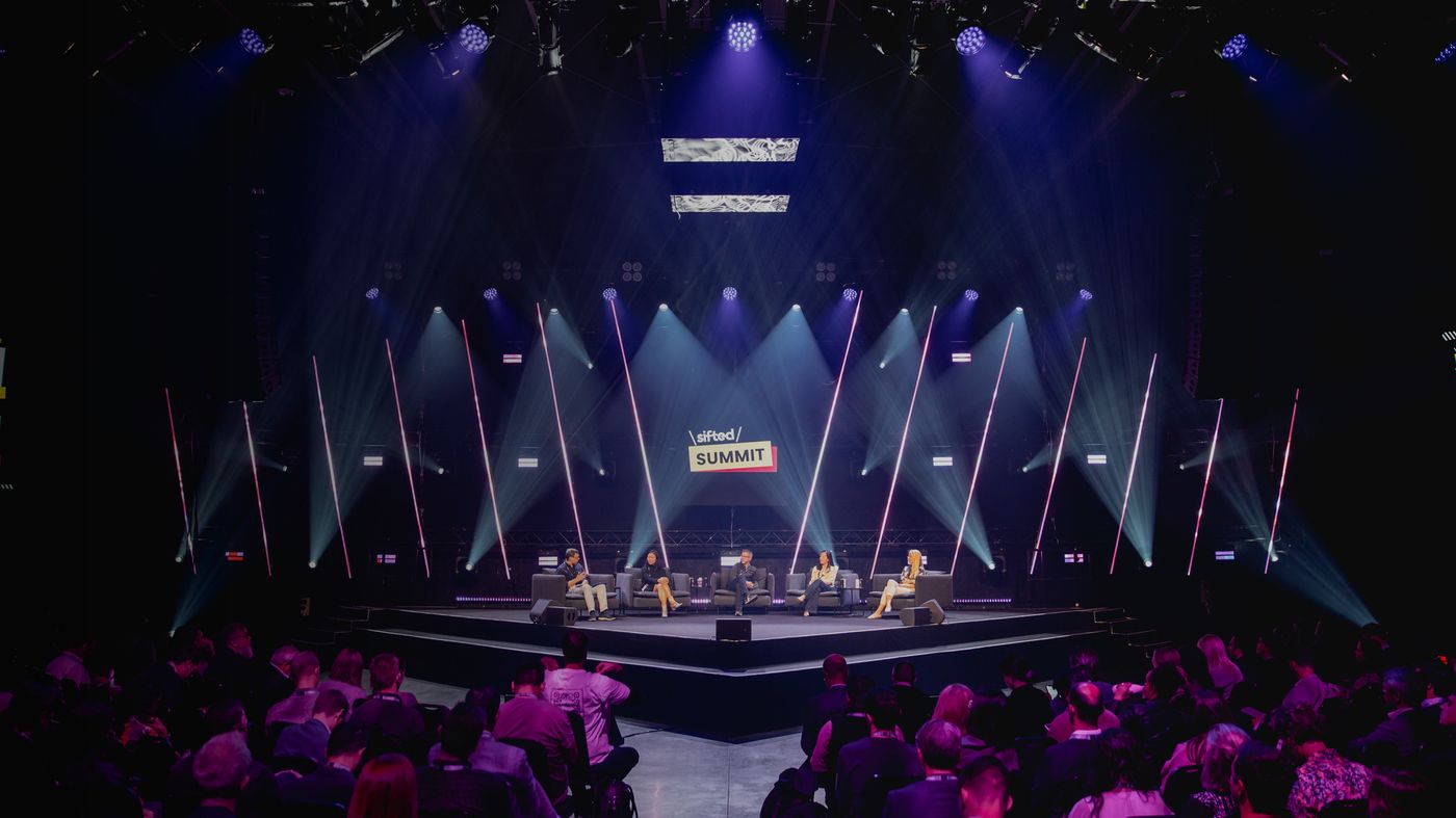 Sifted Summit panel discussion under stage lighting